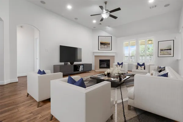 a living room with furniture a fireplace and a flat screen tv