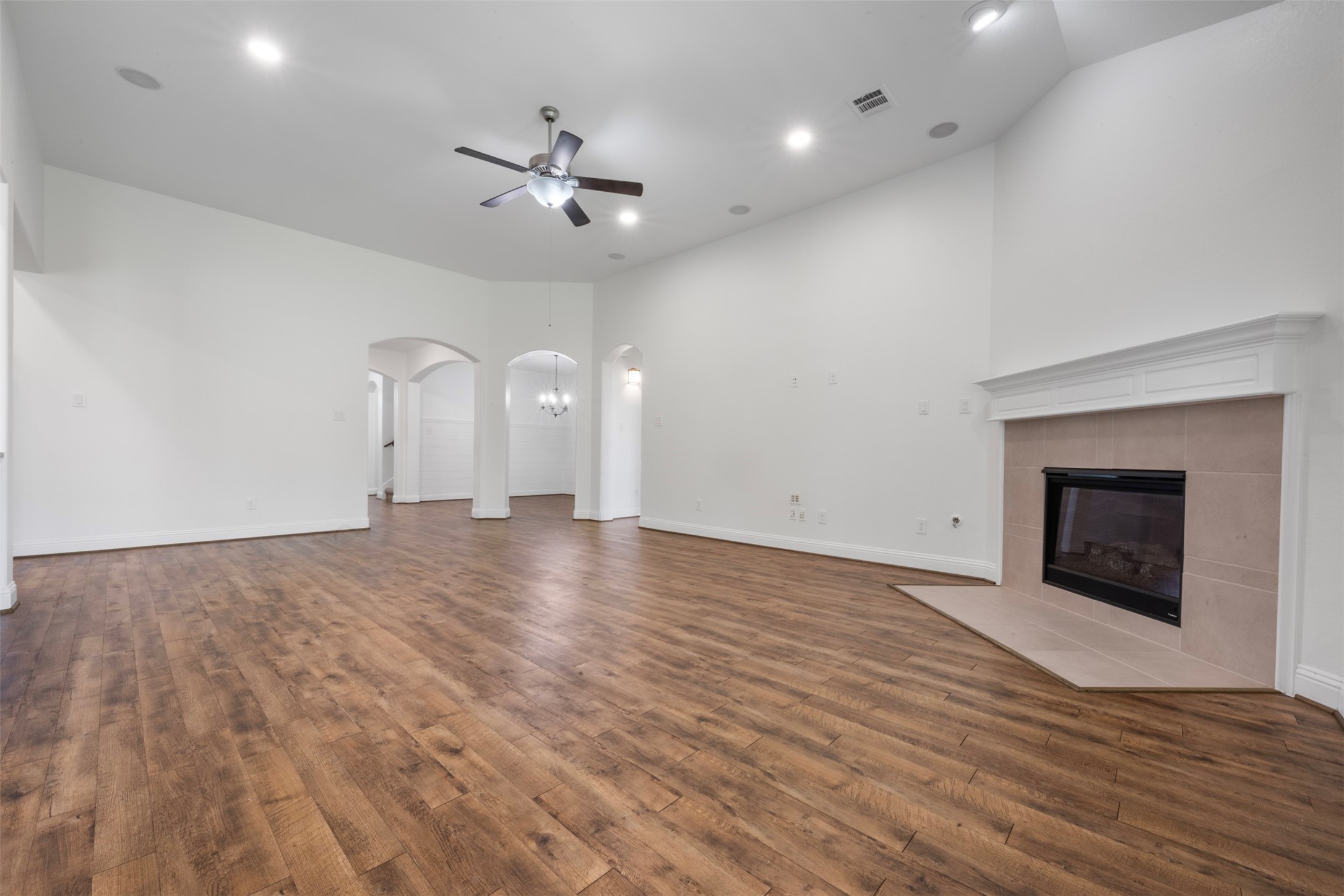 20123 Cascading Falls Boulevard Cypress, TX 77433 - Photo 11 of 41 a view of empty room with wooden floor and fireplace