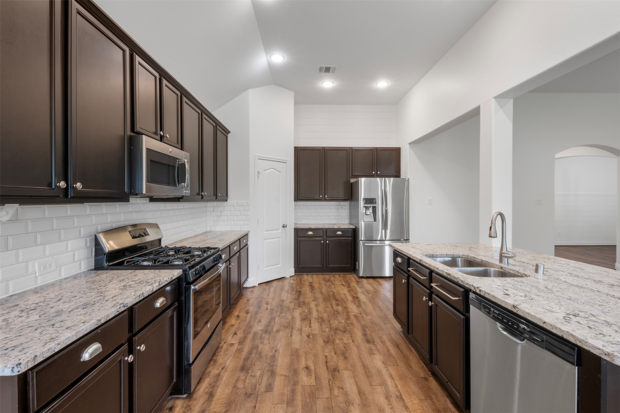 20123 Cascading Falls Boulevard Cypress, TX 77433 - Photo 15 of 41 a kitchen with stainless steel appliances wooden cabinets and a stove top oven