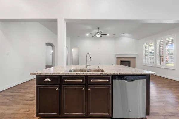 an empty room with a ceiling fan and window