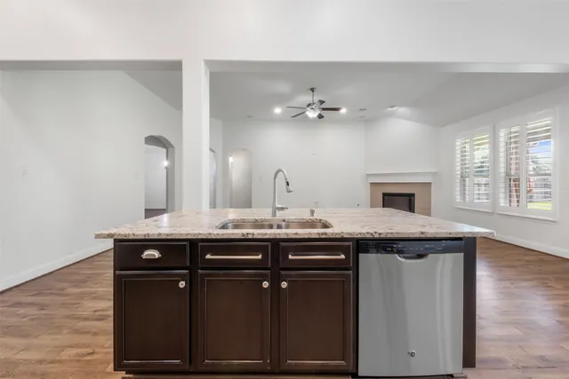 a kitchen with a sink a counter space and a window