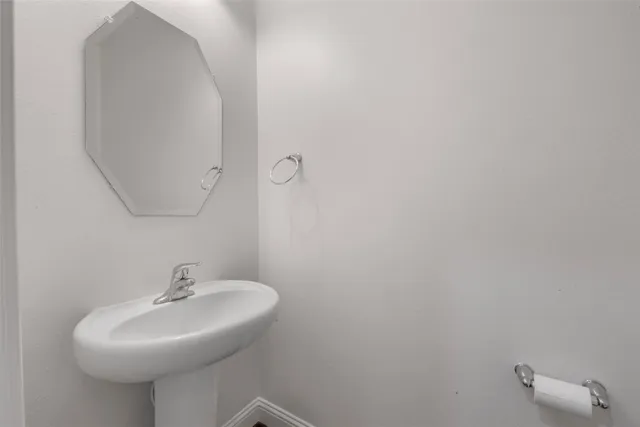 a bathroom with a sink a mirror and vanity