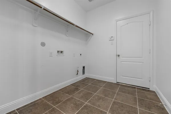 an empty room with a window and a ceiling fan