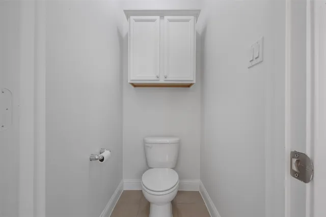 a white toilet sitting next to a shower