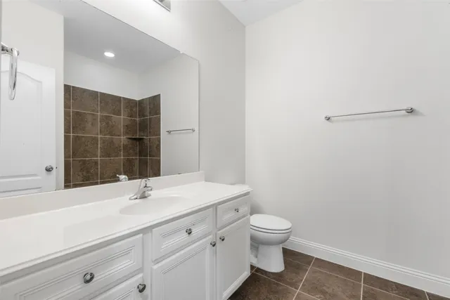 a bathroom with a sink toilet vanity and a tub