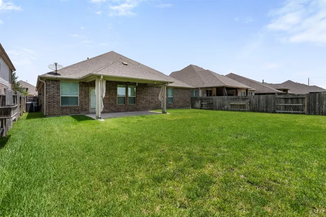a view of a house with a yard and sitting area