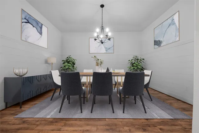 a dining room with furniture potted plants and wooden floor