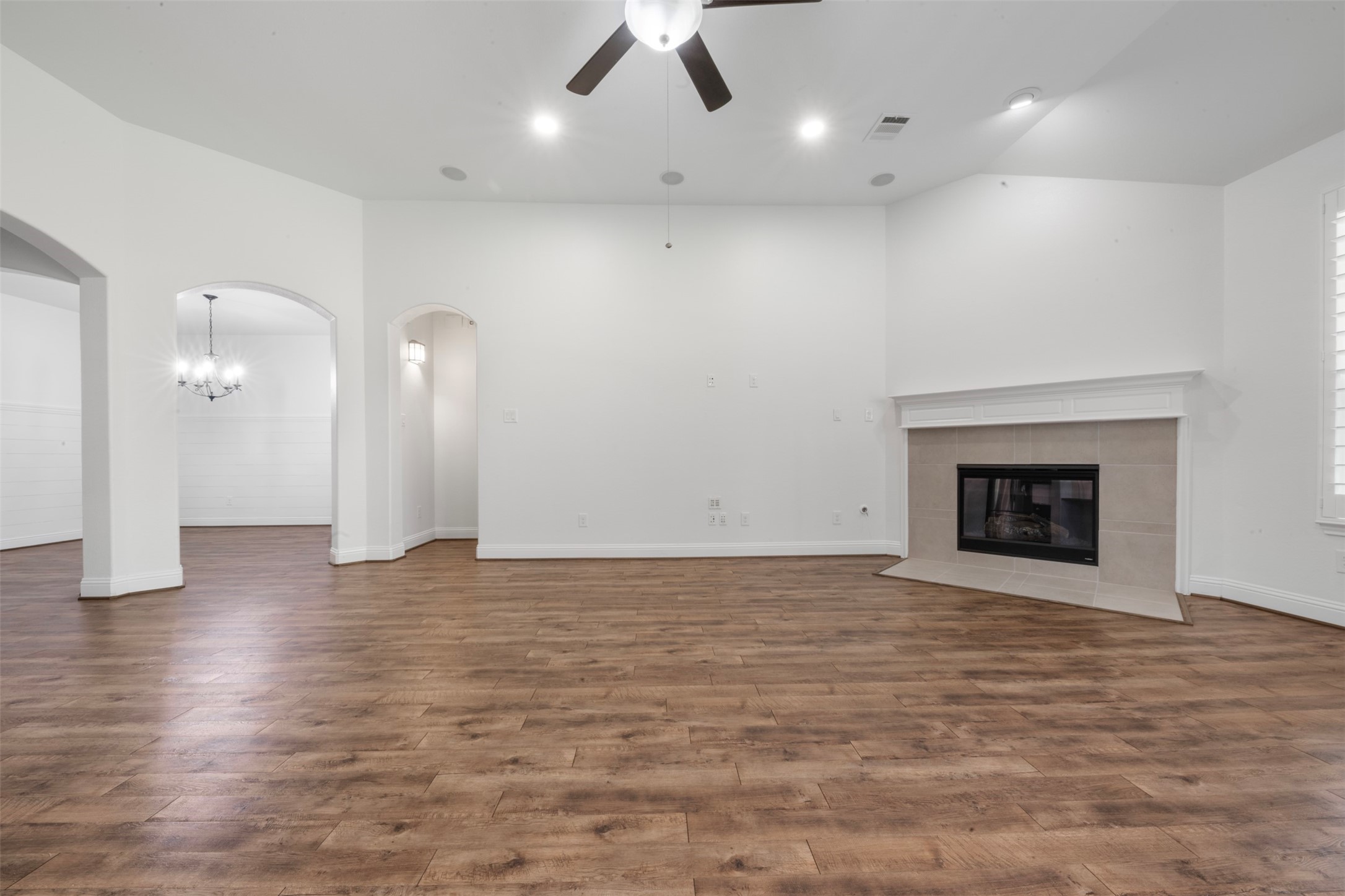 20123 Cascading Falls Boulevard Cypress, TX 77433 - Photo 10 of 41 a view of an empty room with wooden floor and a fireplace