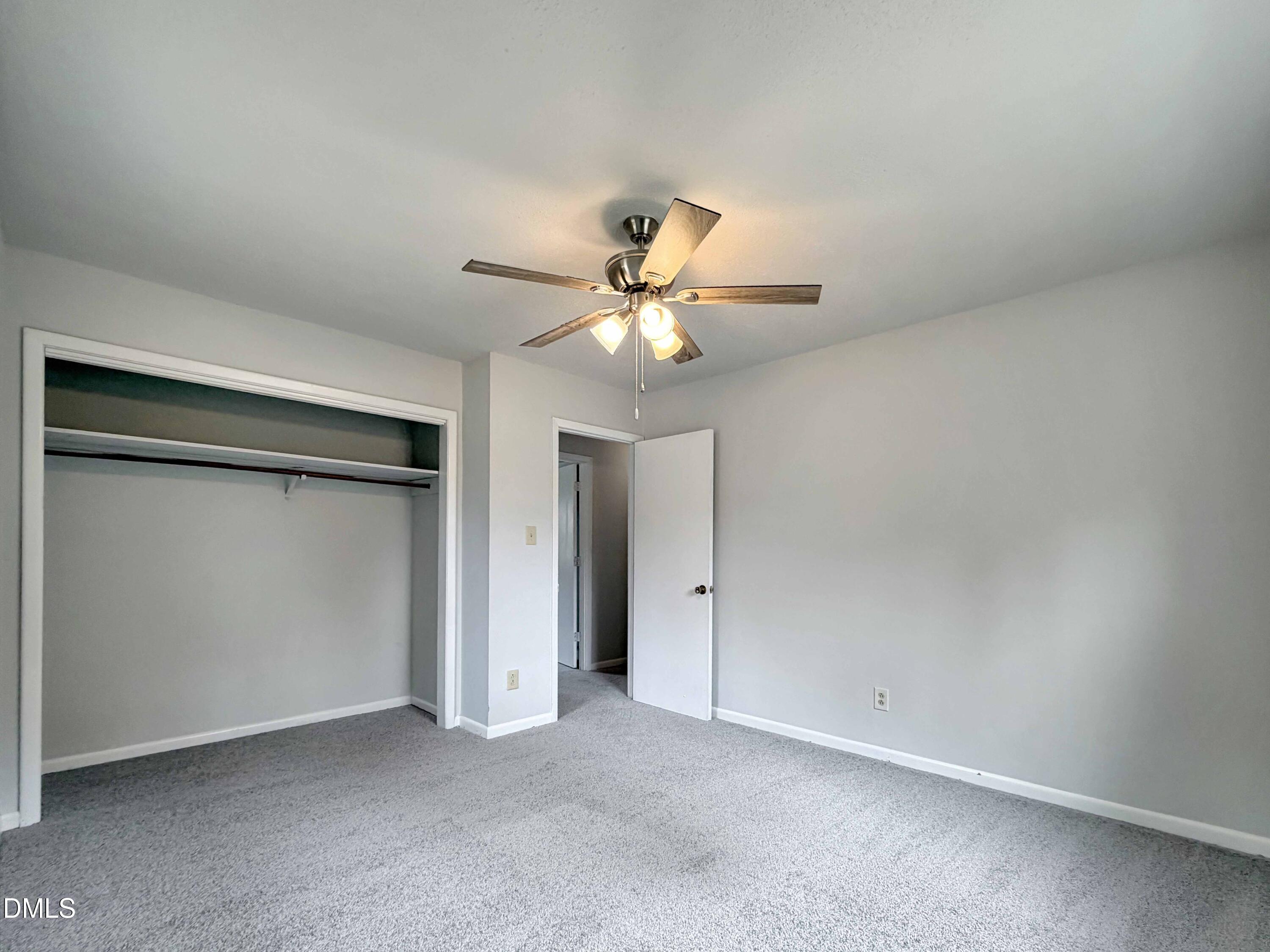 1181 McNeil Street Spring Lake, NC 28390 - Photo 12 of 18 an empty room with a ceiling fan and a window