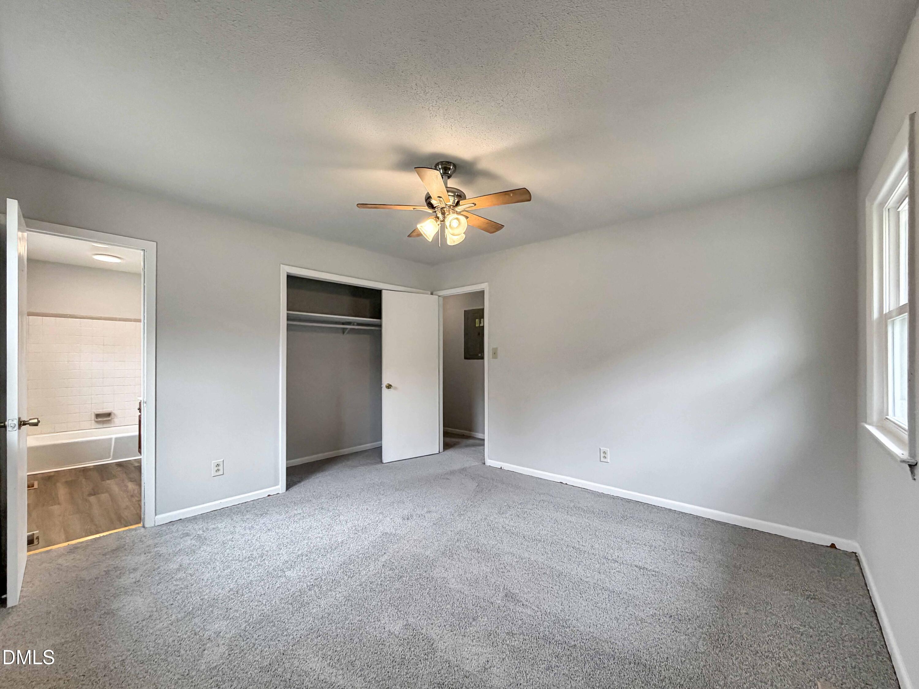 1181 McNeil Street Spring Lake, NC 28390 - Photo 14 of 18 an empty room with chandelier fan and windows