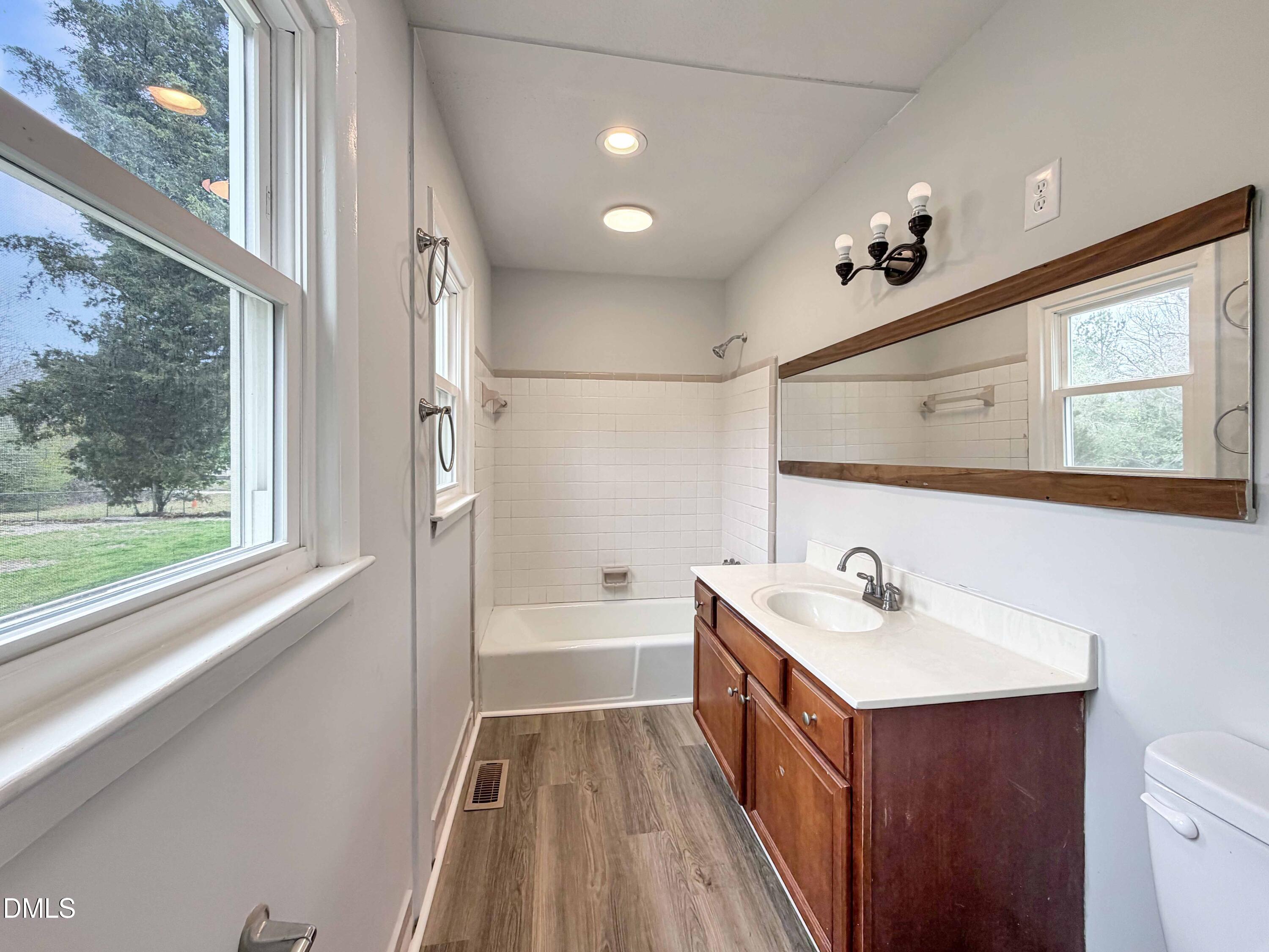 1181 McNeil Street Spring Lake, NC 28390 - Photo 17 of 18 a bathroom with a sink a mirror and a bathtub