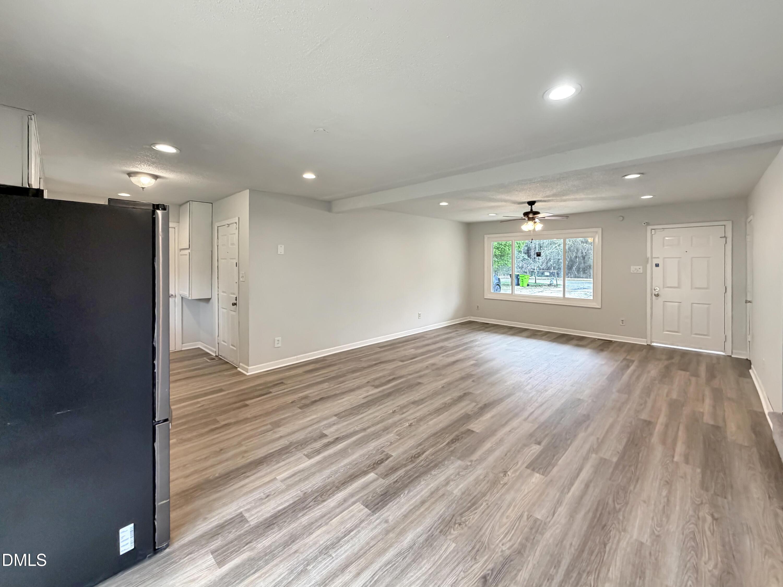 1181 McNeil Street Spring Lake, NC 28390 - Photo 4 of 18 an empty room with wooden floor and windows
