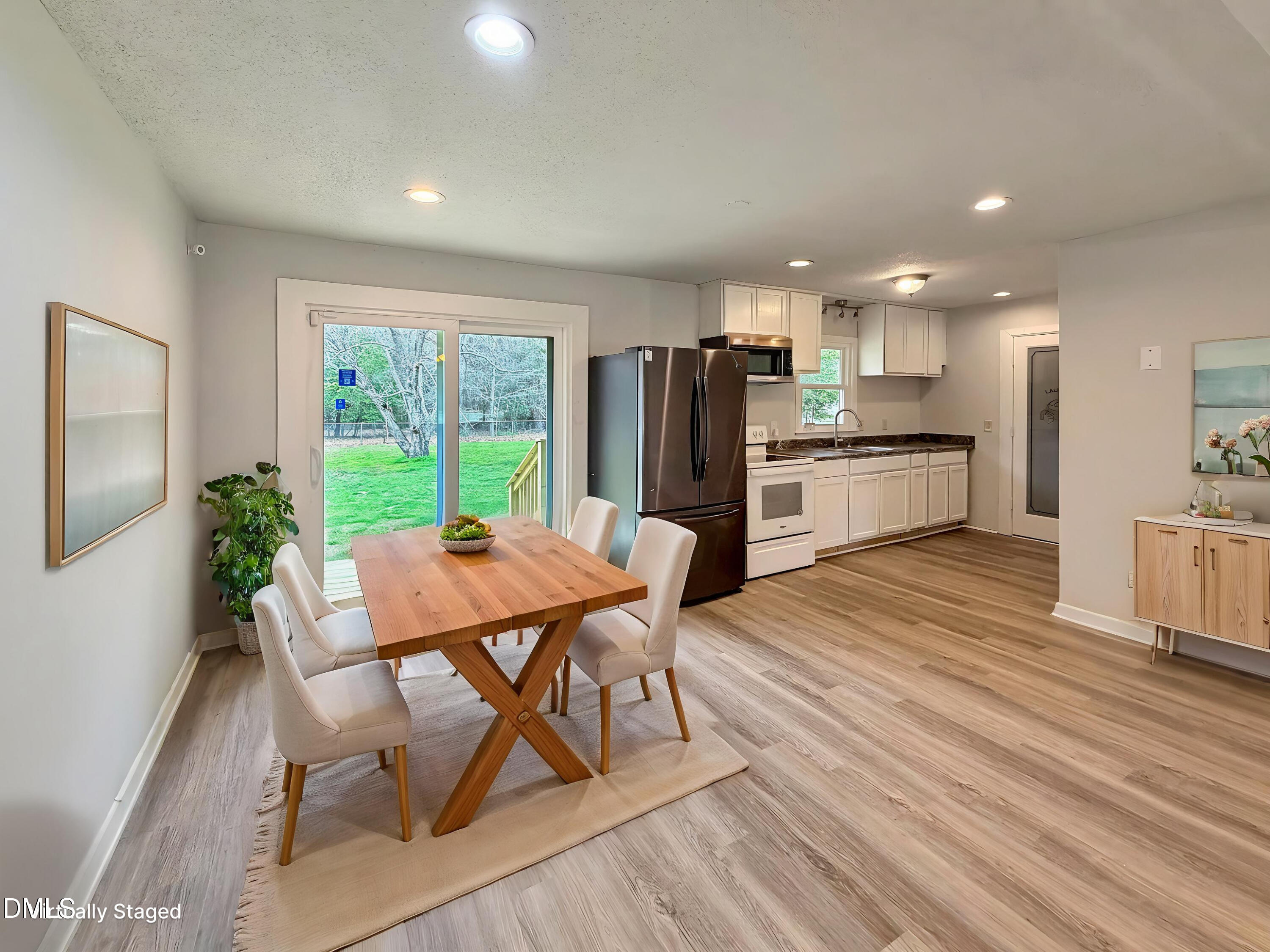 1181 McNeil Street Spring Lake, NC 28390 - Photo 6 of 18 a kitchen with stainless steel appliances kitchen island hardwood floor stove sink a table and chairs in it