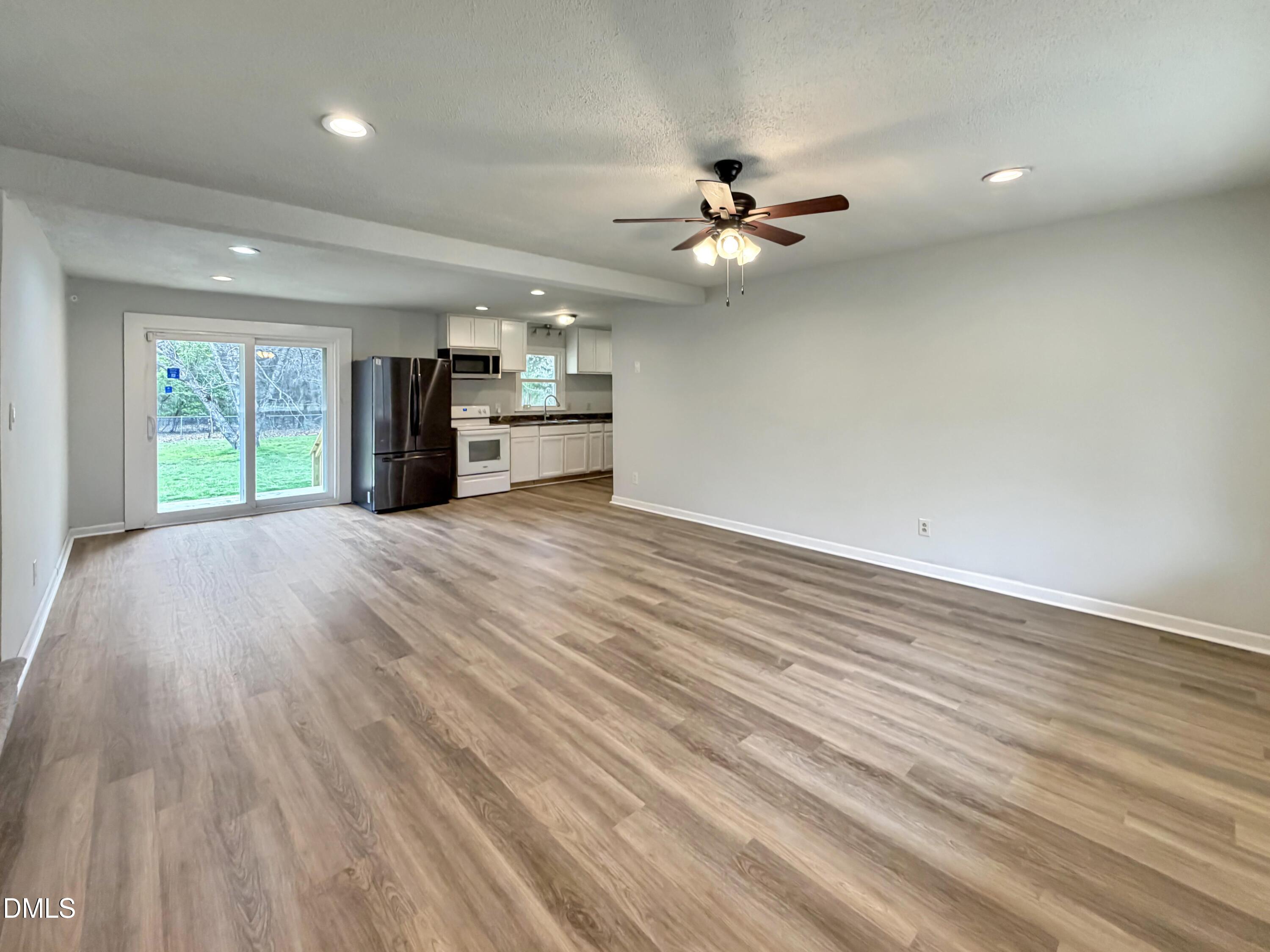 1181 McNeil Street Spring Lake, NC 28390 - Photo 8 of 18 a view of an empty room with a window and wooden floor