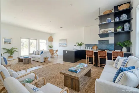 a kitchen with granite countertop a stove a sink dishwasher and a refrigerator with wooden floor