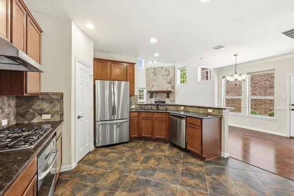 a kitchen with a stove a refrigerator and a sink