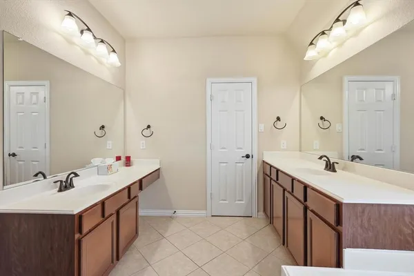 a bathroom with a sink double vanity and a mirror