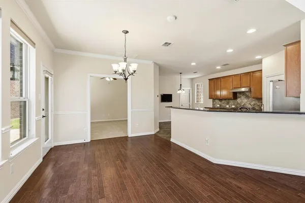 a view of a kitchen with a dishwasher wooden floor and a kitchen