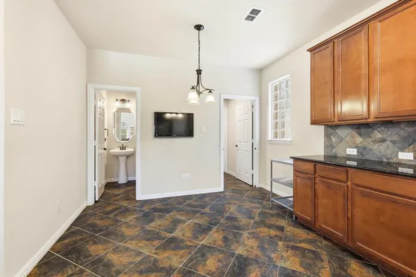 a view of a kitchen with a sink cabinet and a refrigerator
