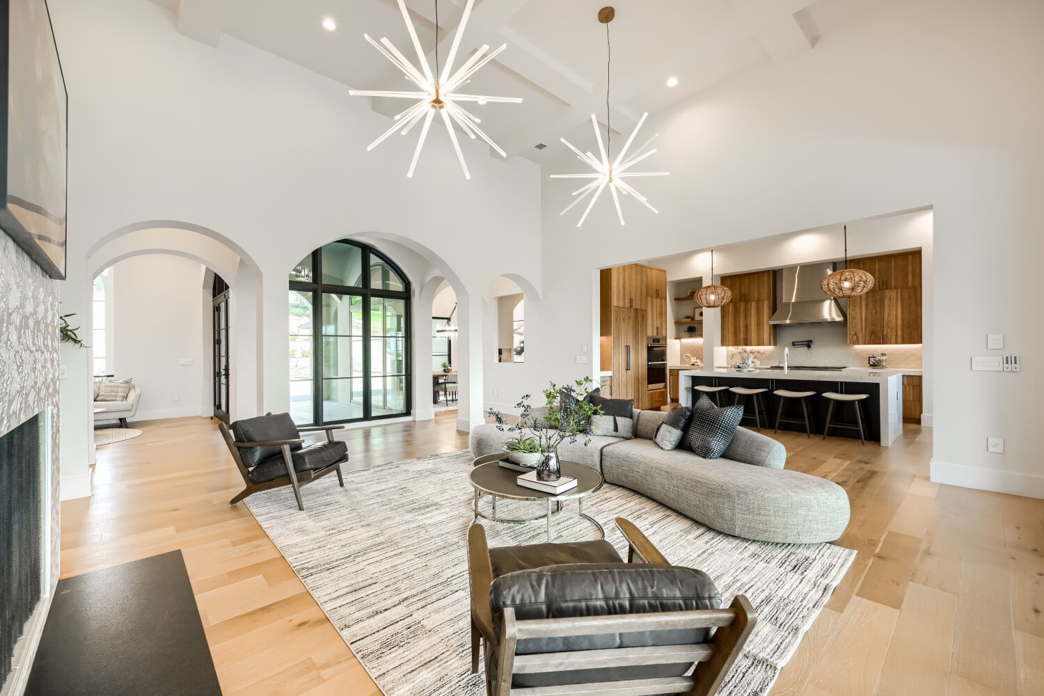 8132 Magnolia Ridge Cove Austin, TX 78738 - Photo 9 of 38 An open-concept living space with high ceilings and arched doorways, featuring a gourmet kitchen and ample natural light.
