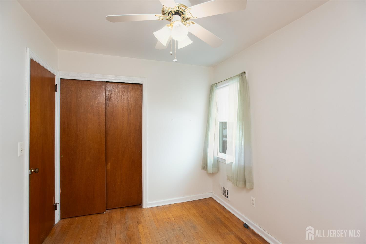 255 Harding Boulevard Matawan, NJ 07747 - Photo 10 of 19 wooden floor in an empty room with a window