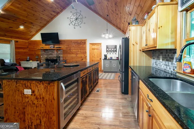 a kitchen filled a sink a counter top space and stainless steel appliances