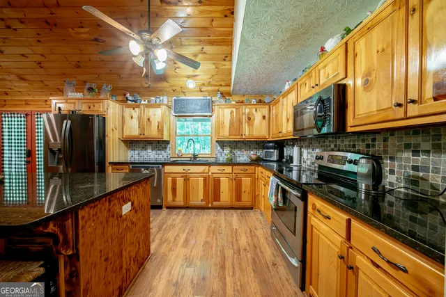 a kitchen with stainless steel appliances granite countertop a stove and a sink