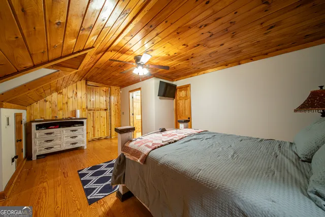 a bedroom with a bed and a tv