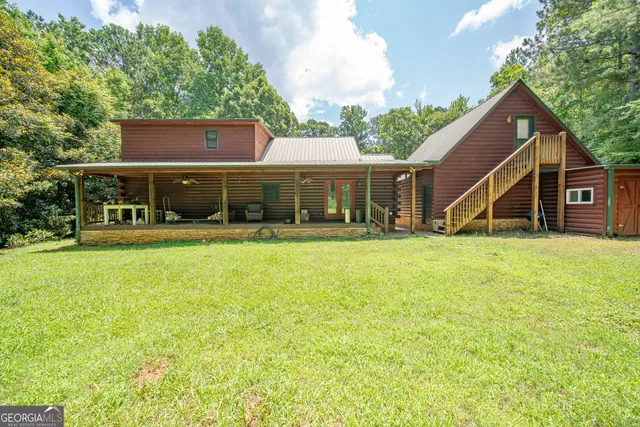 a view of a house with a yard and sitting area
