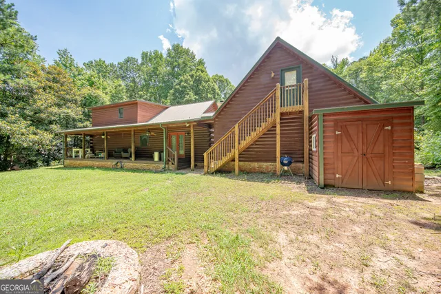 a view of a house with a backyard and stairs