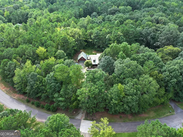 an aerial view of a house with a yard