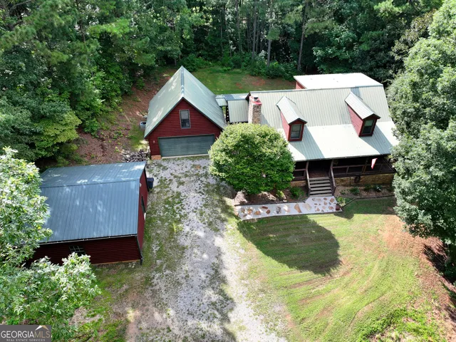 a view of a house with swimming pool and sitting area