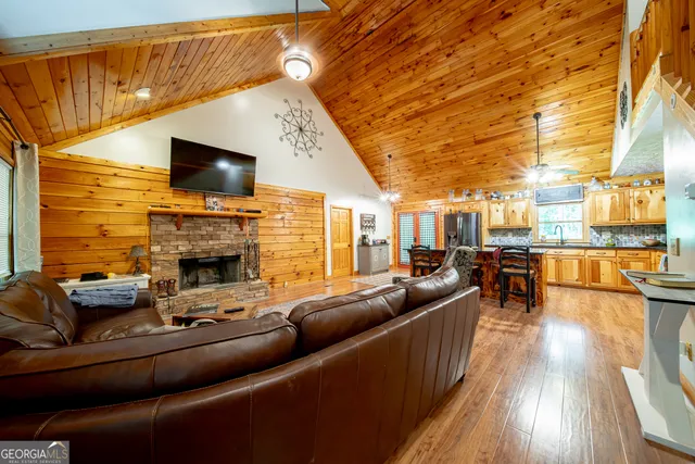 a living room with fireplace furniture and a flat screen tv