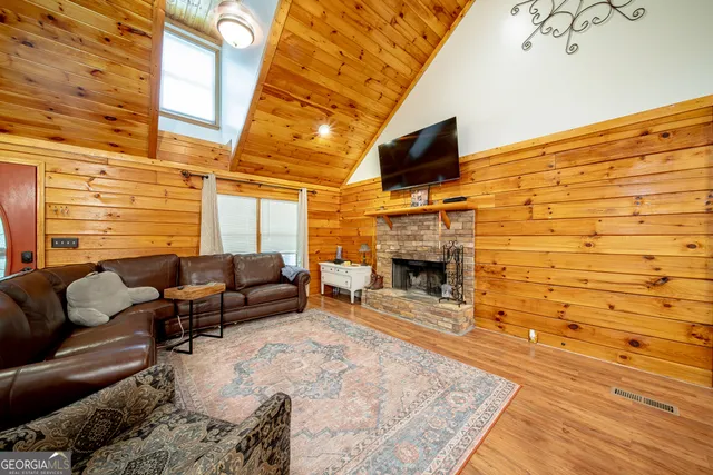 a living room with furniture flat screen tv and a fireplace