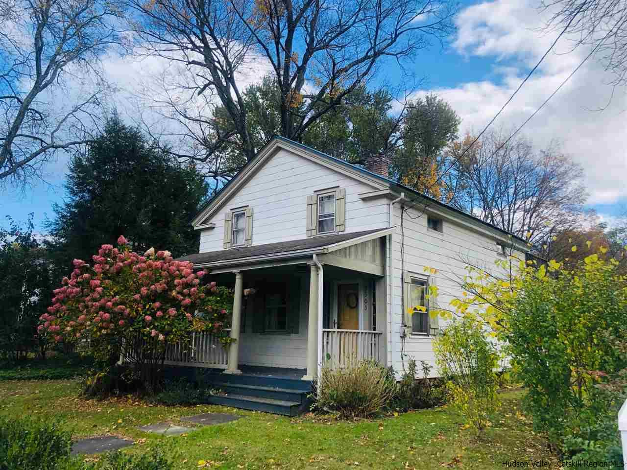 a view of house with a yard and flower garden