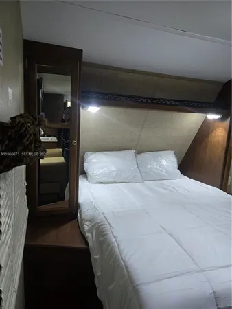 a bedroom with a bed and a mirror