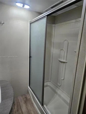 a bathroom with a glass shower door