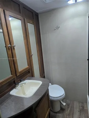 a bathroom with a sink a toilet and mirror