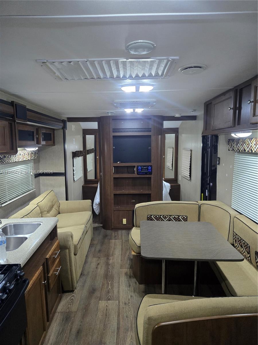 10935 Southwest 217th Terrace Miami, FL 33170 - Photo 2 of 13 a living room with furniture and a flat screen tv