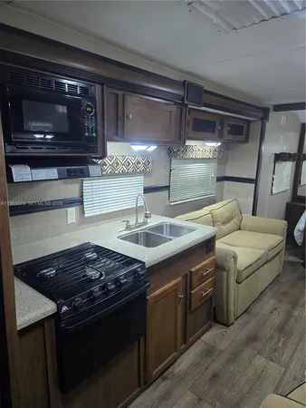 a kitchen with stainless steel appliances granite countertop a stove and a microwave