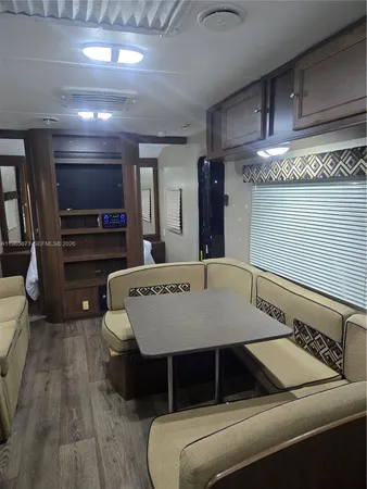 a large kitchen with a table and chairs