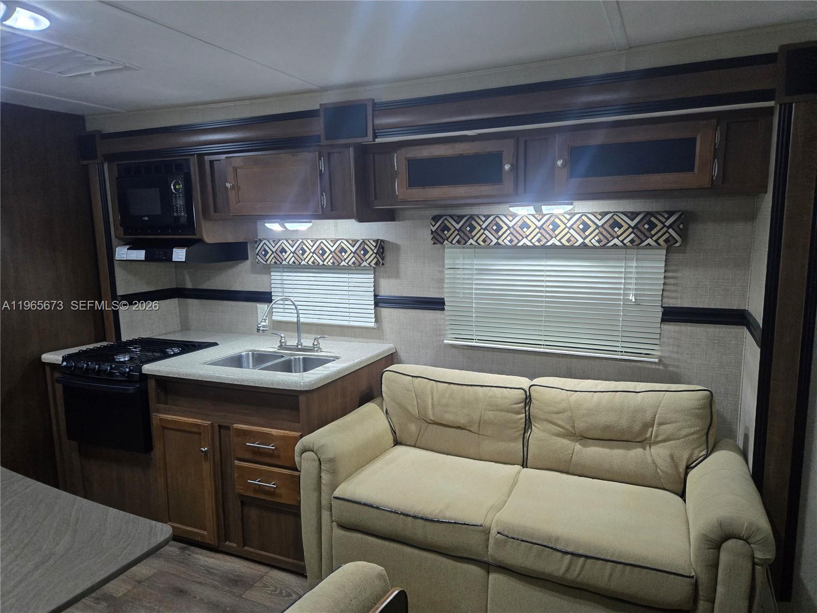 10935 Southwest 217th Terrace Miami, FL 33170 - Photo 6 of 13 a living room with furniture and a fireplace