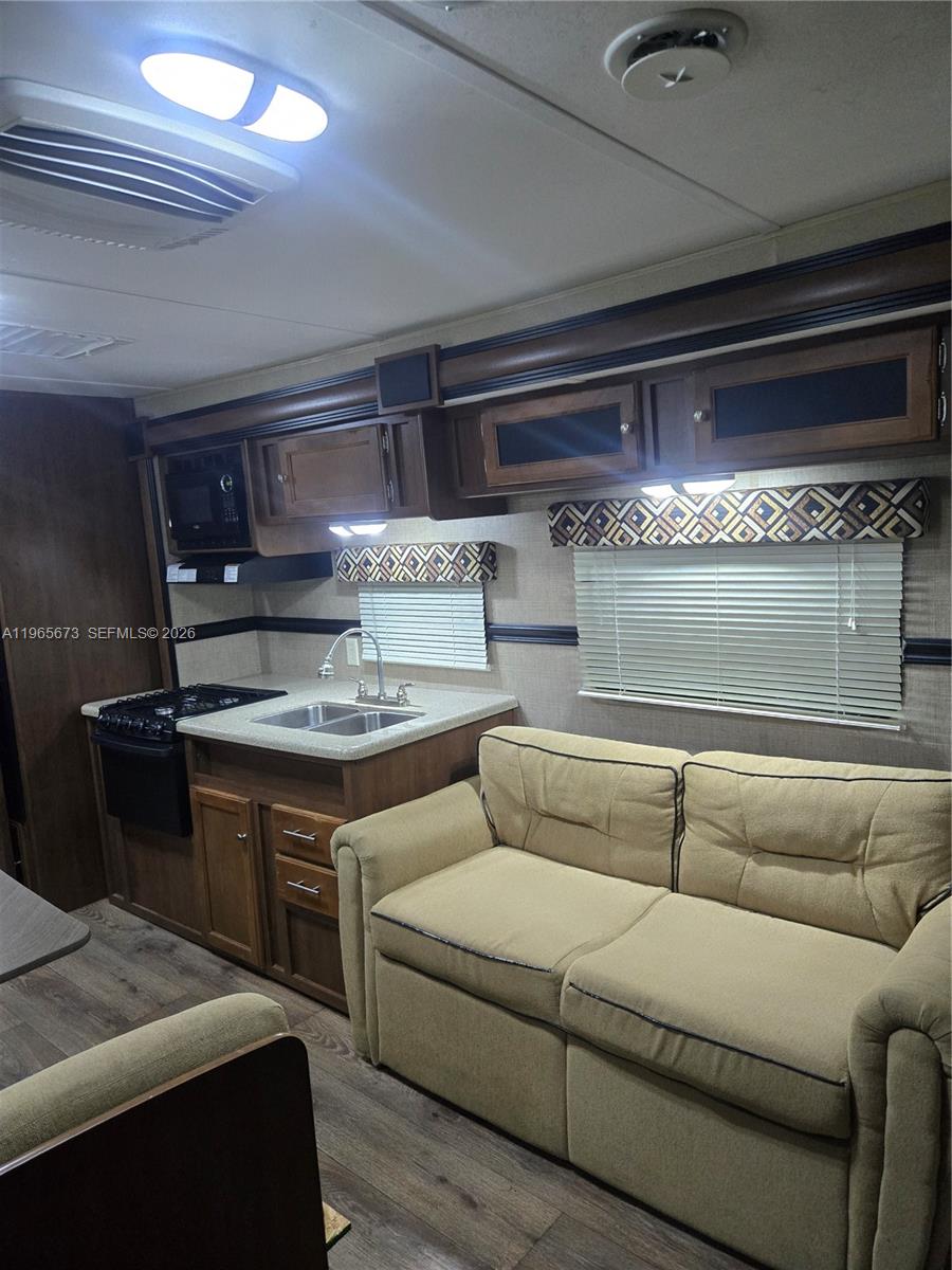 10935 Southwest 217th Terrace Miami, FL 33170 - Photo 7 of 13 a living room with furniture and a fireplace