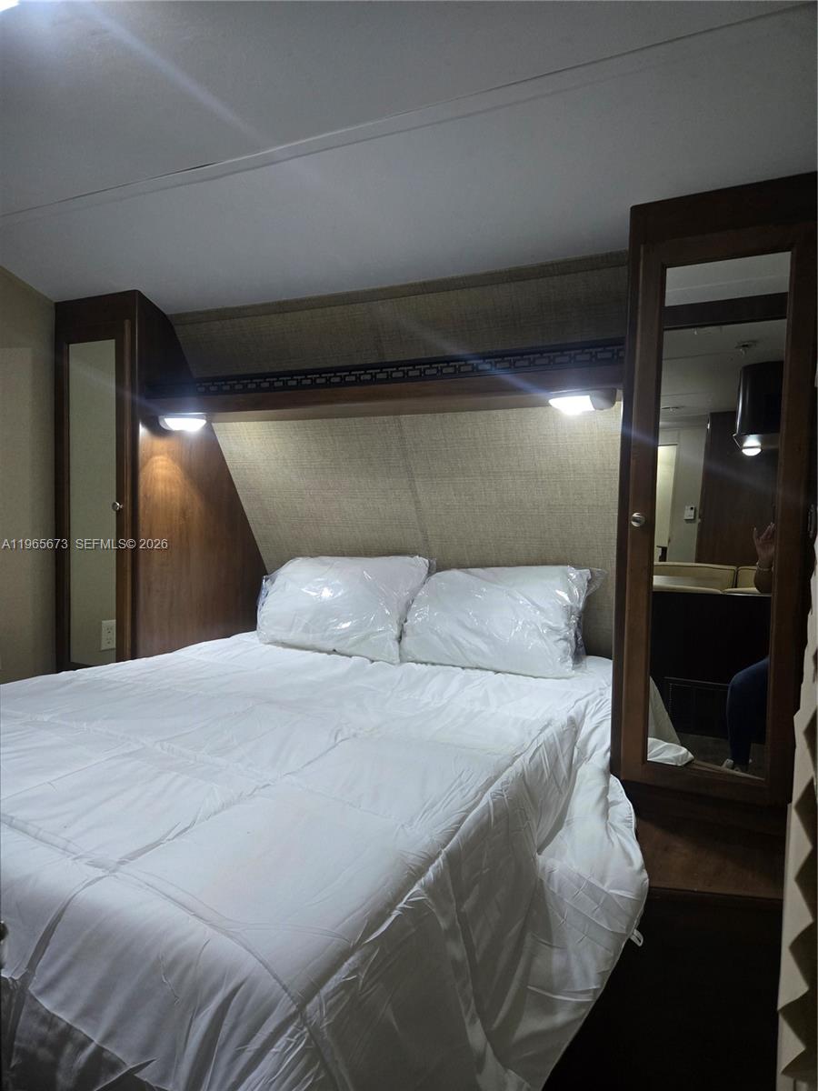 10935 Southwest 217th Terrace Miami, FL 33170 - Photo 10 of 13 a large bed sitting in a bedroom and a mirror