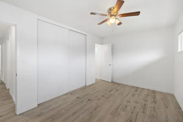 an empty room with fan and a ceiling fan