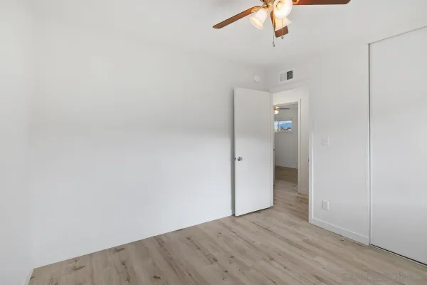 a view of an empty room with a fan