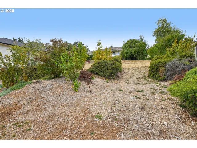a backyard of a house with a yard and outdoor seating