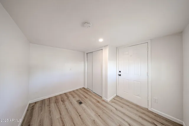 a view of a room with wooden floor and windows