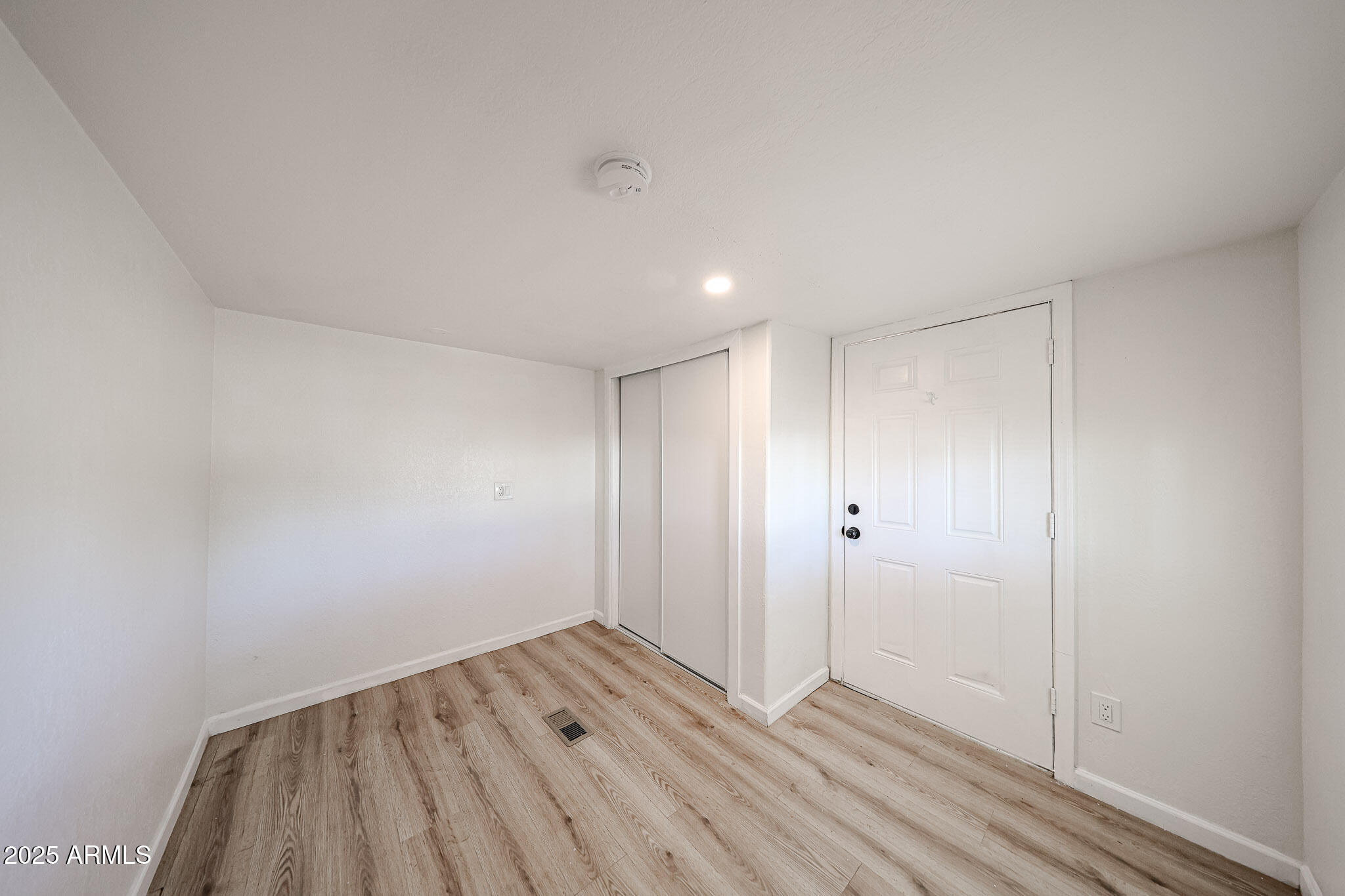2839 East Marco Polo Road Phoenix, AZ 85050 - Photo 14 of 43 a view of an empty room with wooden floor