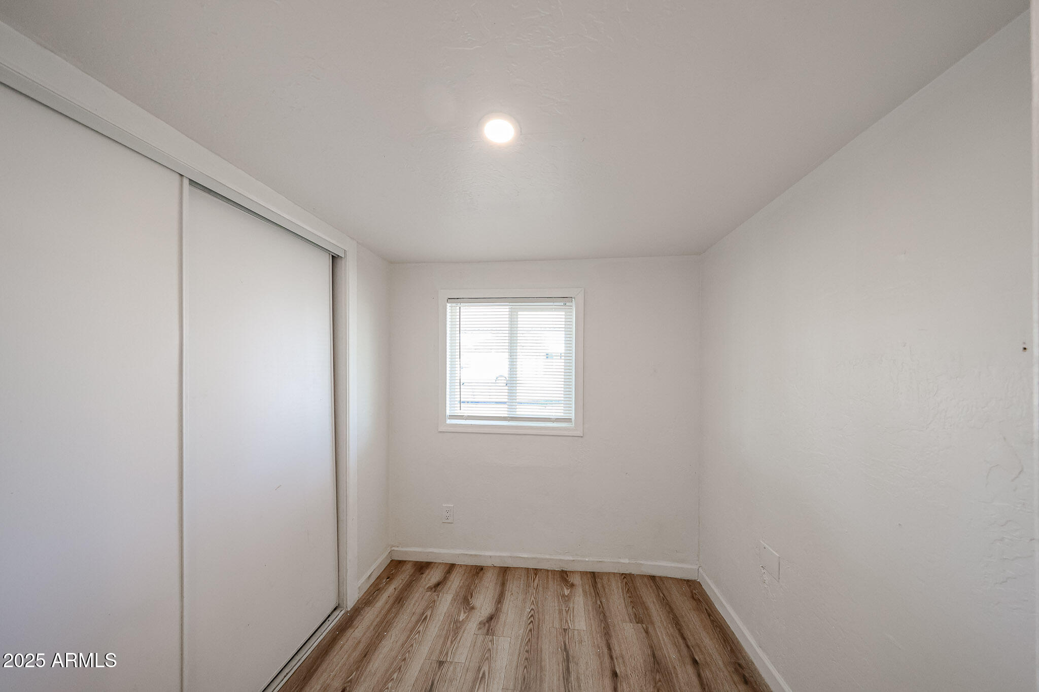 2839 East Marco Polo Road Phoenix, AZ 85050 - Photo 15 of 43 a view of a room with wooden floor and windows